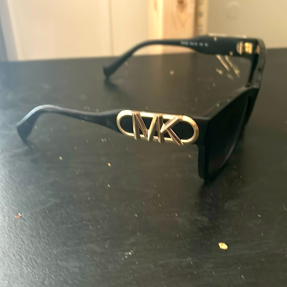 Brand new Micheal khors sun glasses black with gold letters asking